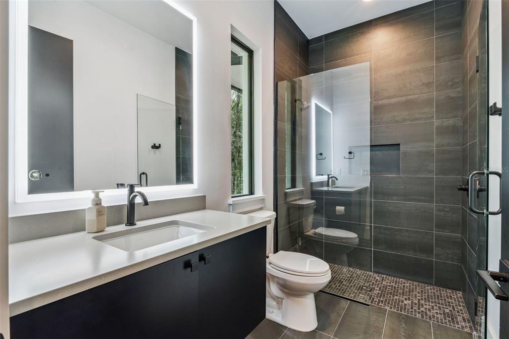 15746 Pendio Drive Montverde, FL 34756 - Photo 25 of 71 a bathroom with a sink a toilet and shower