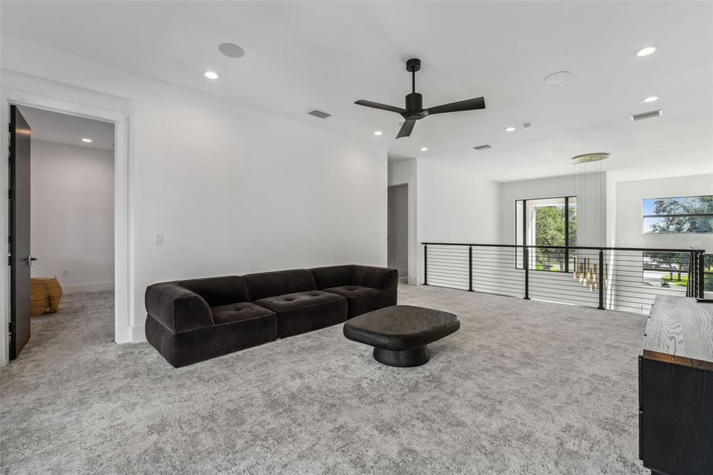 15746 Pendio Drive Montverde, FL 34756 - Photo 28 of 71 a living room with furniture and a flat screen tv