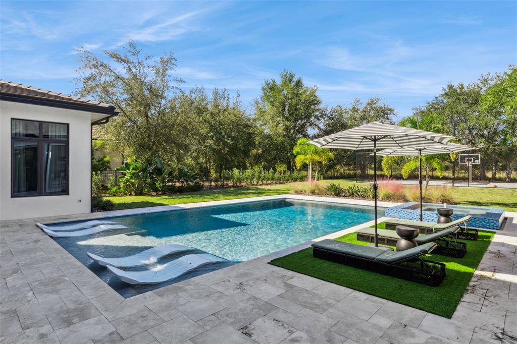 15746 Pendio Drive Montverde, FL 34756 - Photo 45 of 71 a swimming pool with outdoor seating yard and barbeque oven