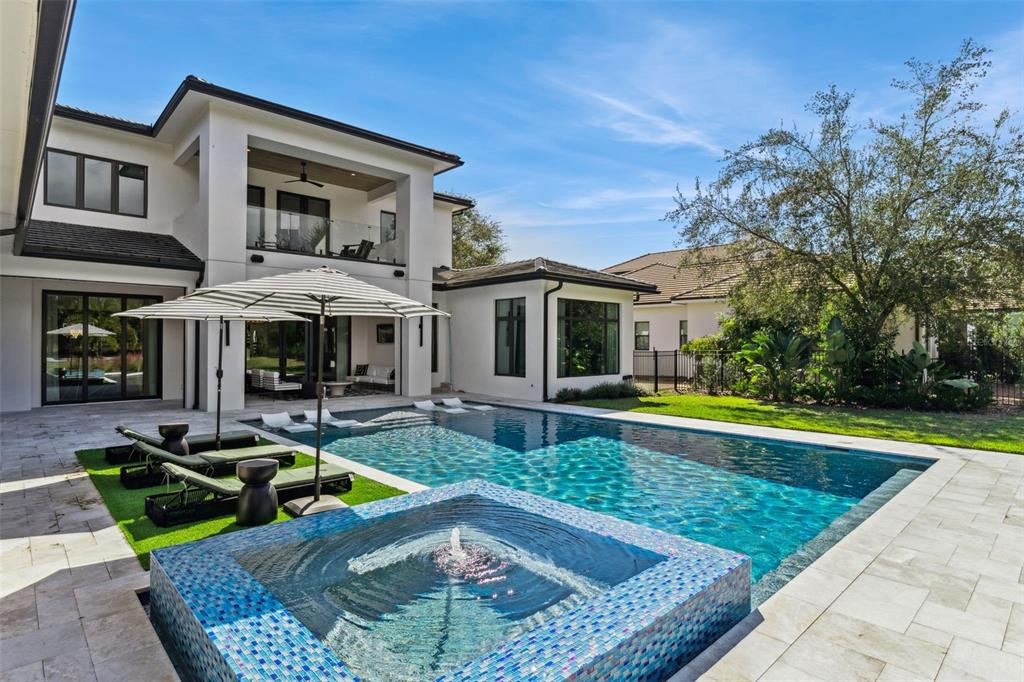 15746 Pendio Drive Montverde, FL 34756 - Photo 46 of 71 a view of a house with swimming pool and sitting area