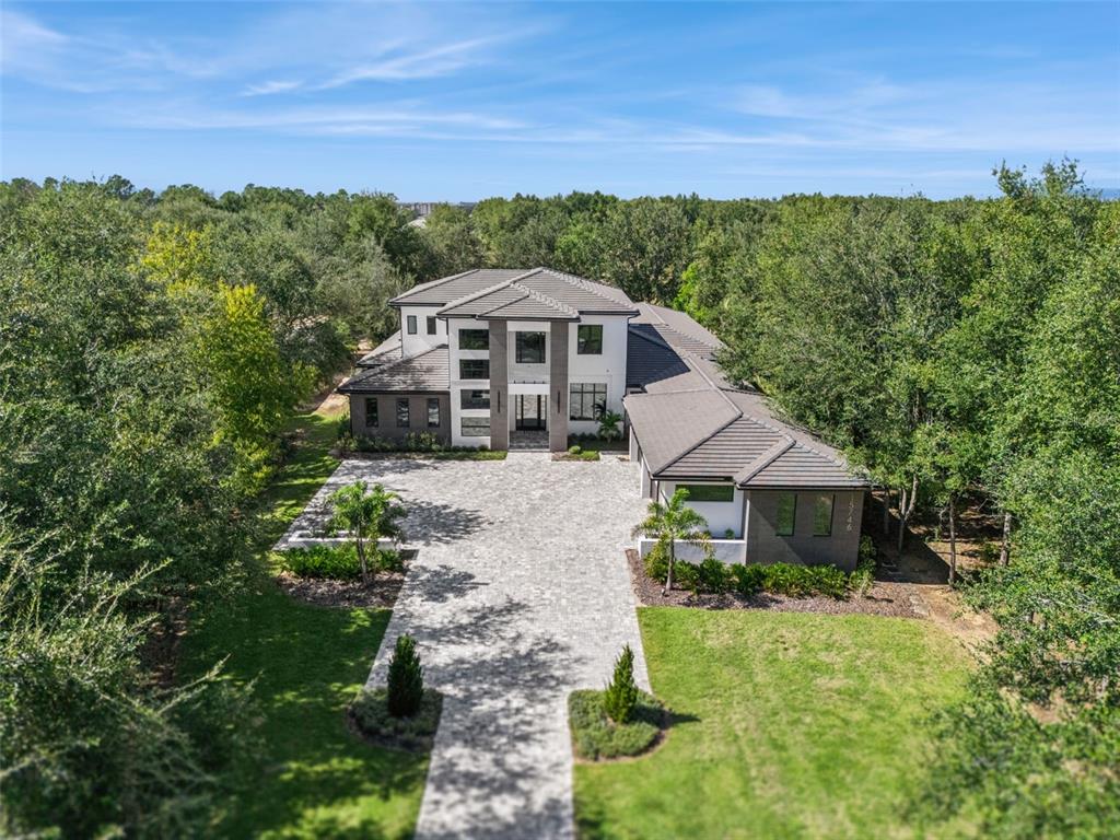 15746 Pendio Drive Montverde, FL 34756 - Photo 54 of 71 a front view of a house with a yard