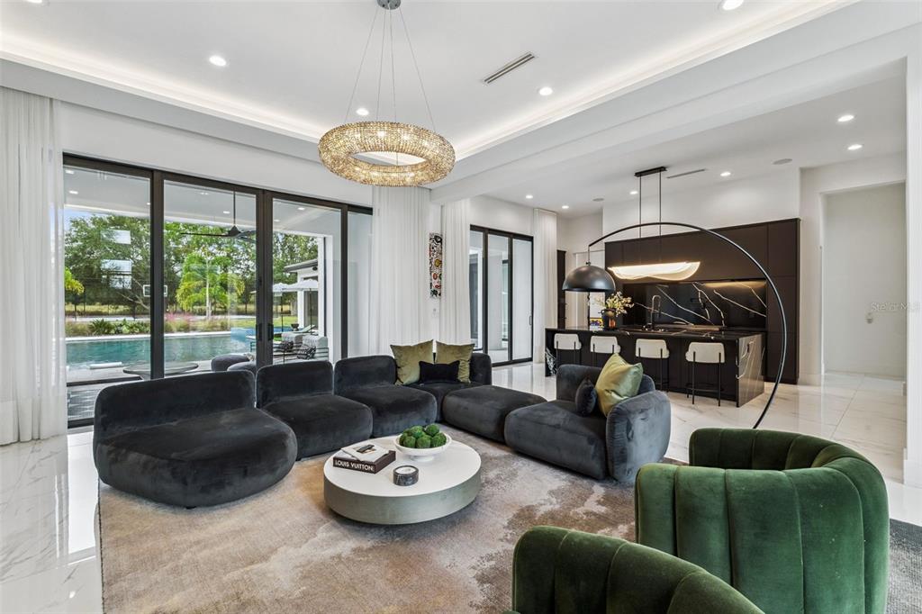 15746 Pendio Drive Montverde, FL 34756 - Photo 8 of 71 a large living room with furniture and a large window