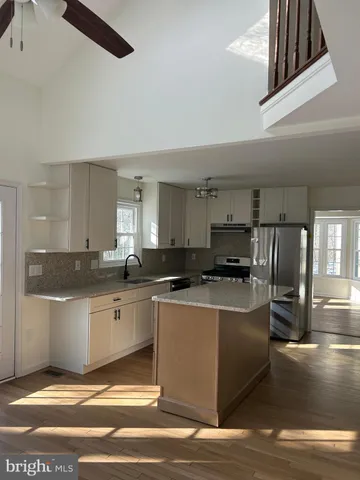 a kitchen with stainless steel appliances granite countertop a sink and stove