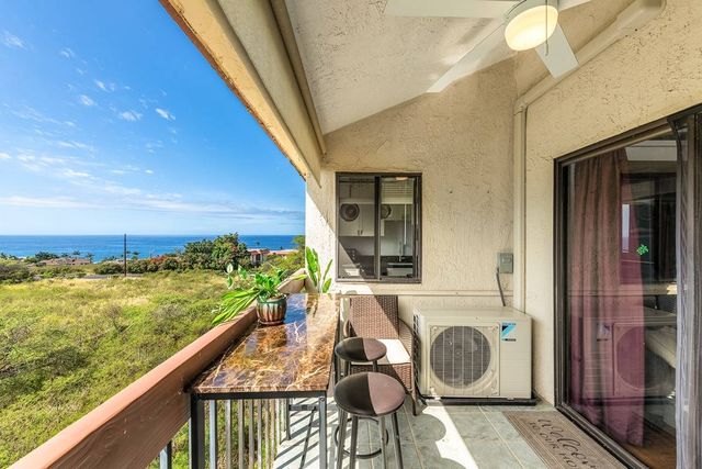a view of a balcony with chair and wooden floor