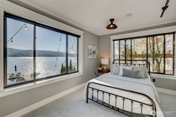 a bedroom with a large bed and a large window