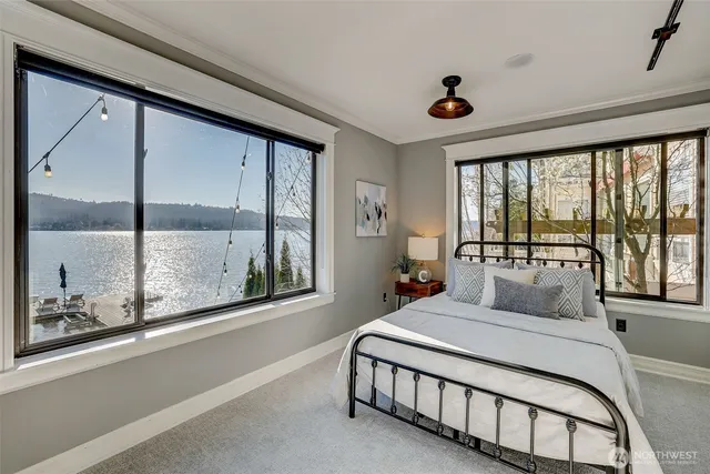 a bedroom with a large bed and a large window