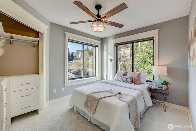 a bedroom with a bed and a large window