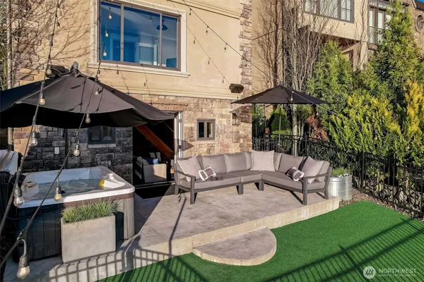 a patio with a table and chairs under an umbrella