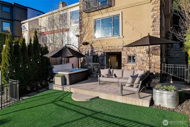 a view of a house with backyard and sitting area