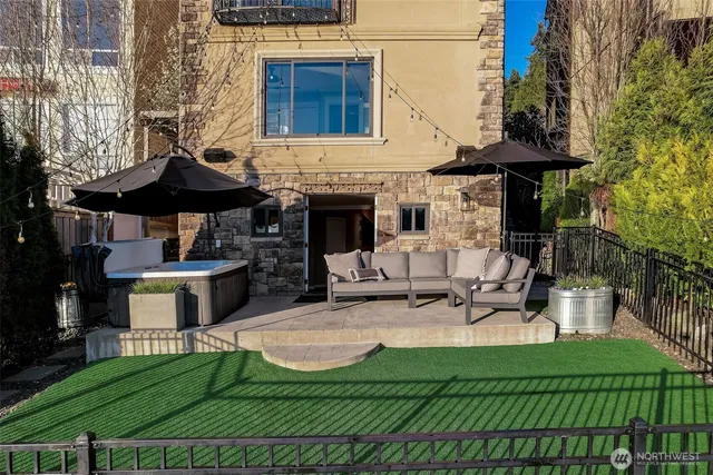 a view of a patio with table and chairs under an umbrella with a fire pit and a fire pit