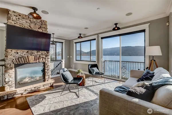 a living room with furniture a flat screen tv and a fireplace