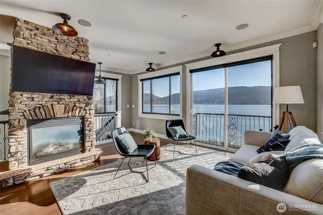 a living room with furniture a flat screen tv and a fireplace