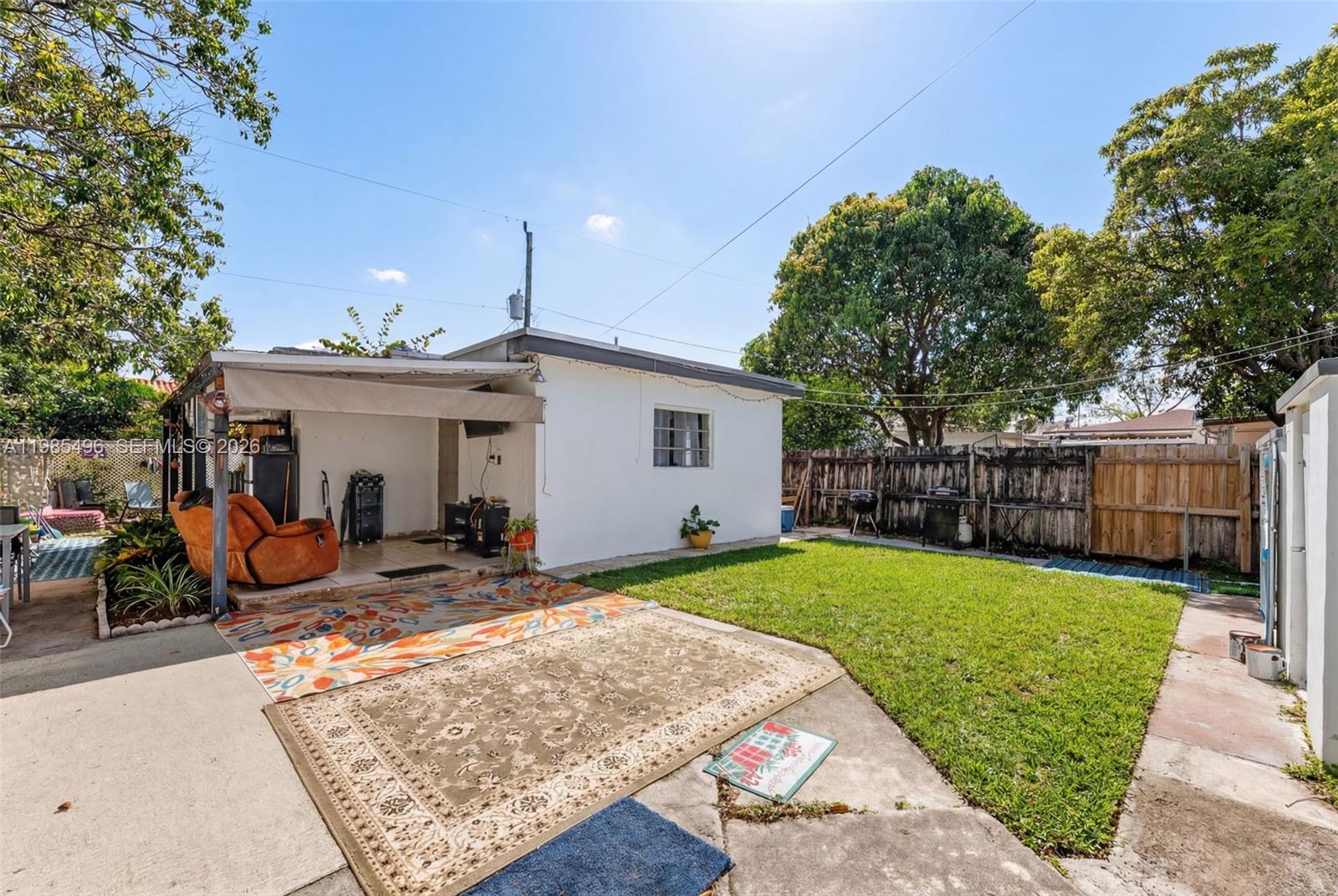 440 East 37th Street Hialeah, FL 33013 - Photo 14 of 27 a view of a house with backyard sitting area and tree