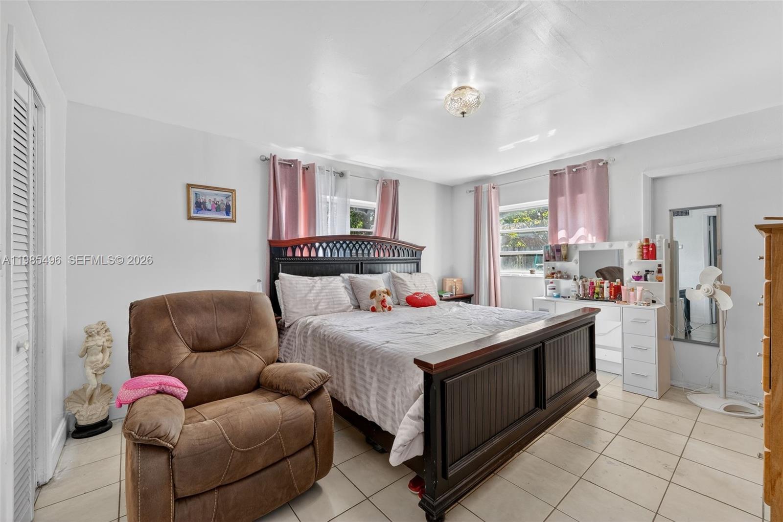 440 East 37th Street Hialeah, FL 33013 - Photo 16 of 27 a bedroom with furniture and a couch