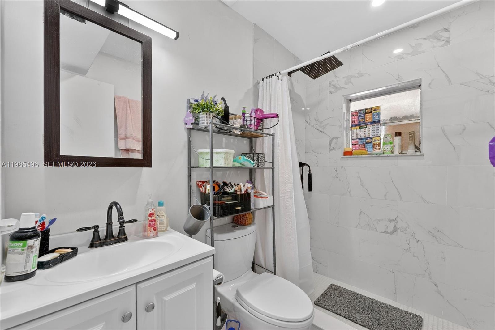 440 East 37th Street Hialeah, FL 33013 - Photo 17 of 27 a bathroom with a sink vanity mirror and toilet