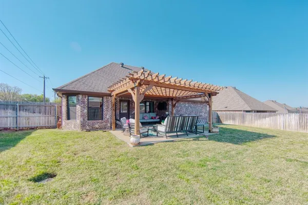 a view of a house with a yard and sitting area
