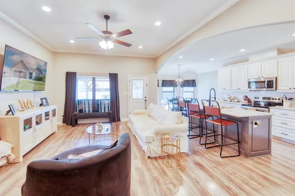 a living room with furniture and kitchen view