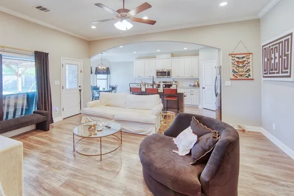 a living room with furniture and a wooden floor