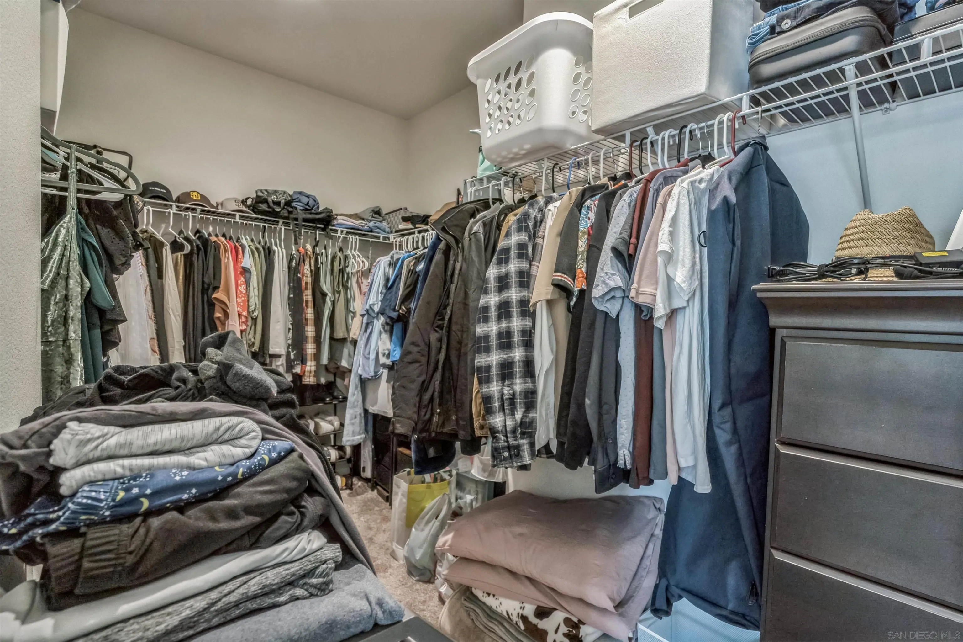 2018 Barite Street Spring Valley, CA 91977 - Photo 22 of 47 a view of walk in closet with clothes