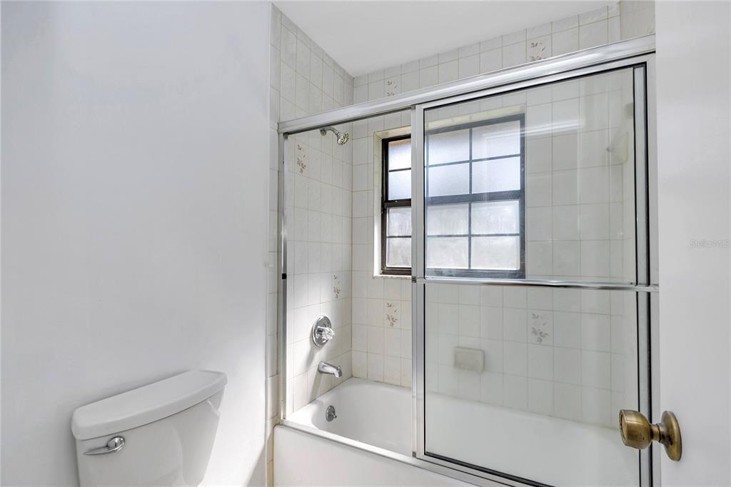 8160 Southwest 53rd Court Ocala, FL 34476 - Photo 20 of 54 a bathroom with a glass shower door