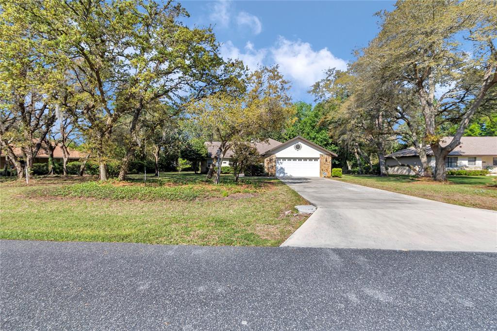 8160 Southwest 53rd Court Ocala, FL 34476 - Photo 2 of 54 a front view of a house with a yard and garage
