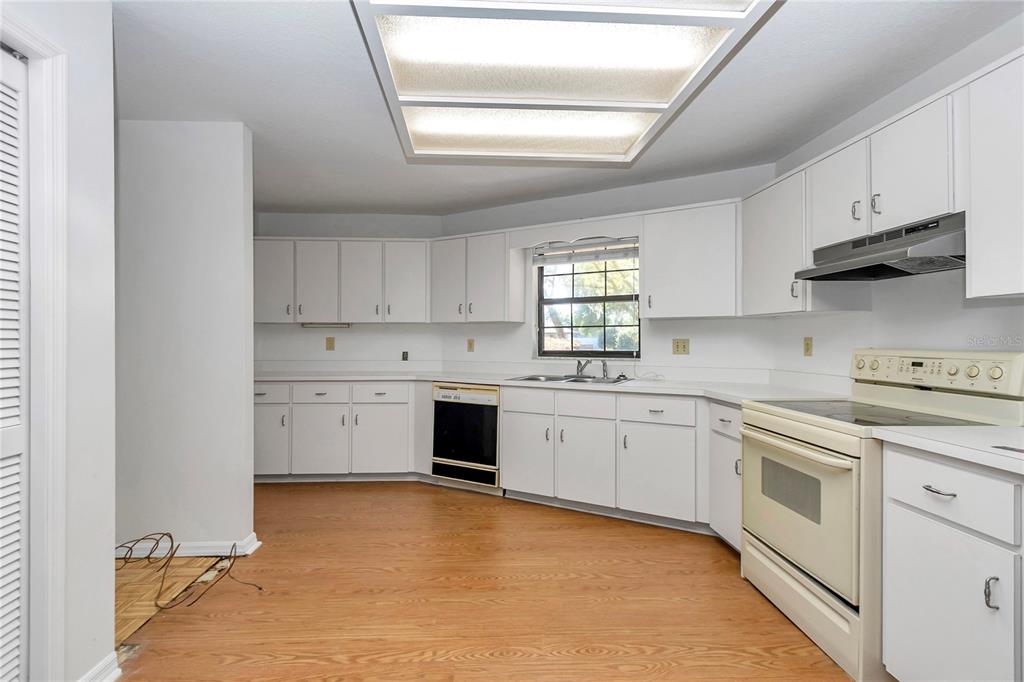 8160 Southwest 53rd Court Ocala, FL 34476 - Photo 26 of 54 a kitchen with white cabinets appliances and a window