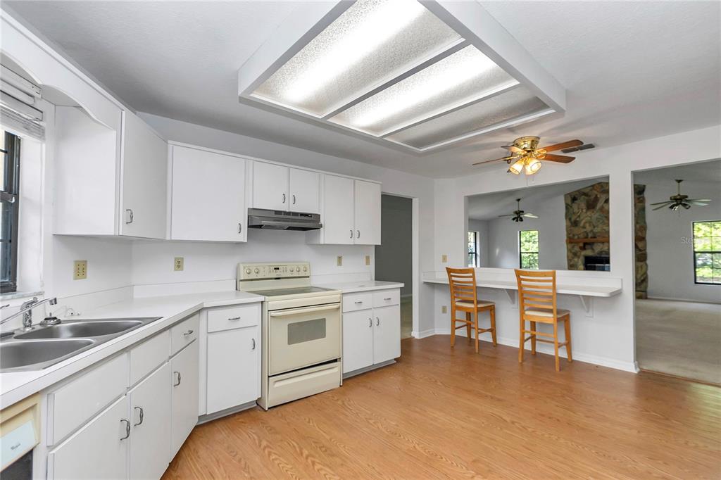 8160 Southwest 53rd Court Ocala, FL 34476 - Photo 30 of 54 a kitchen with stainless steel appliances granite countertop a sink dishwasher stove and white cabinets