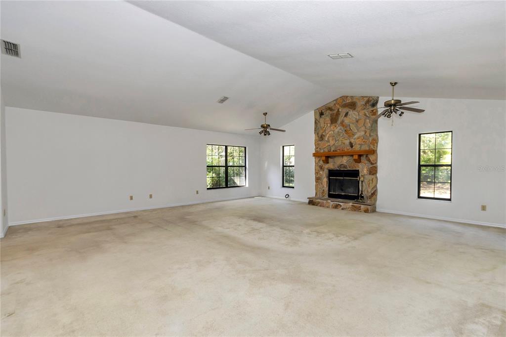 8160 Southwest 53rd Court Ocala, FL 34476 - Photo 33 of 54 an empty room with windows and fireplace