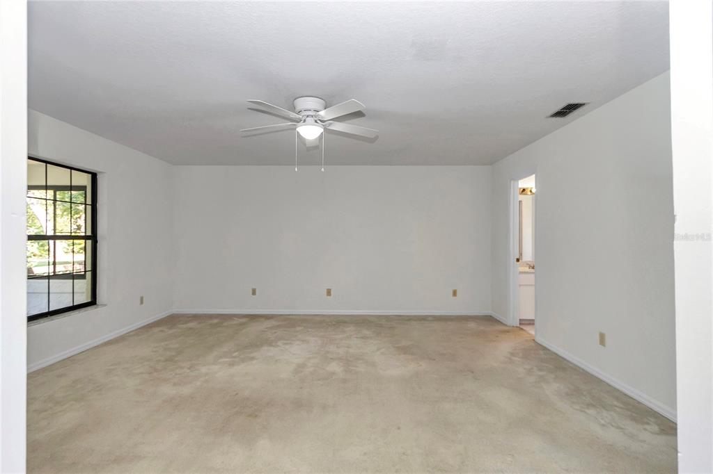 8160 Southwest 53rd Court Ocala, FL 34476 - Photo 34 of 54 an empty room with windows and ceiling fan