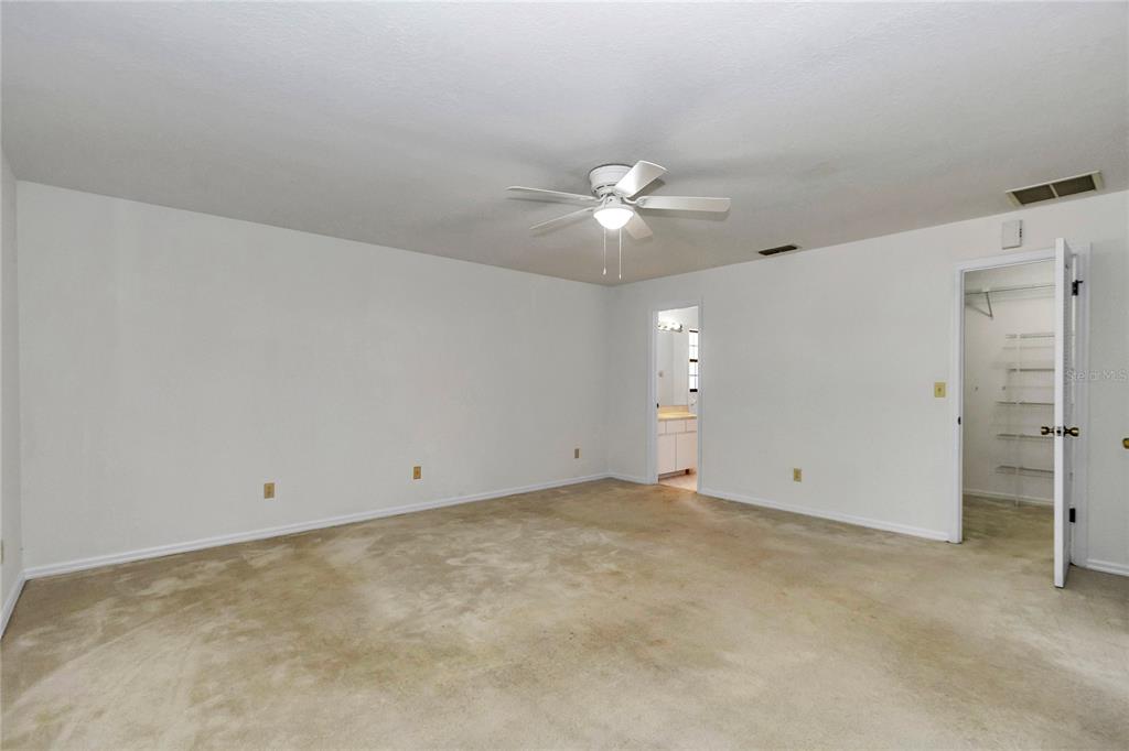 8160 Southwest 53rd Court Ocala, FL 34476 - Photo 35 of 54 an empty room with a ceiling fan and a window