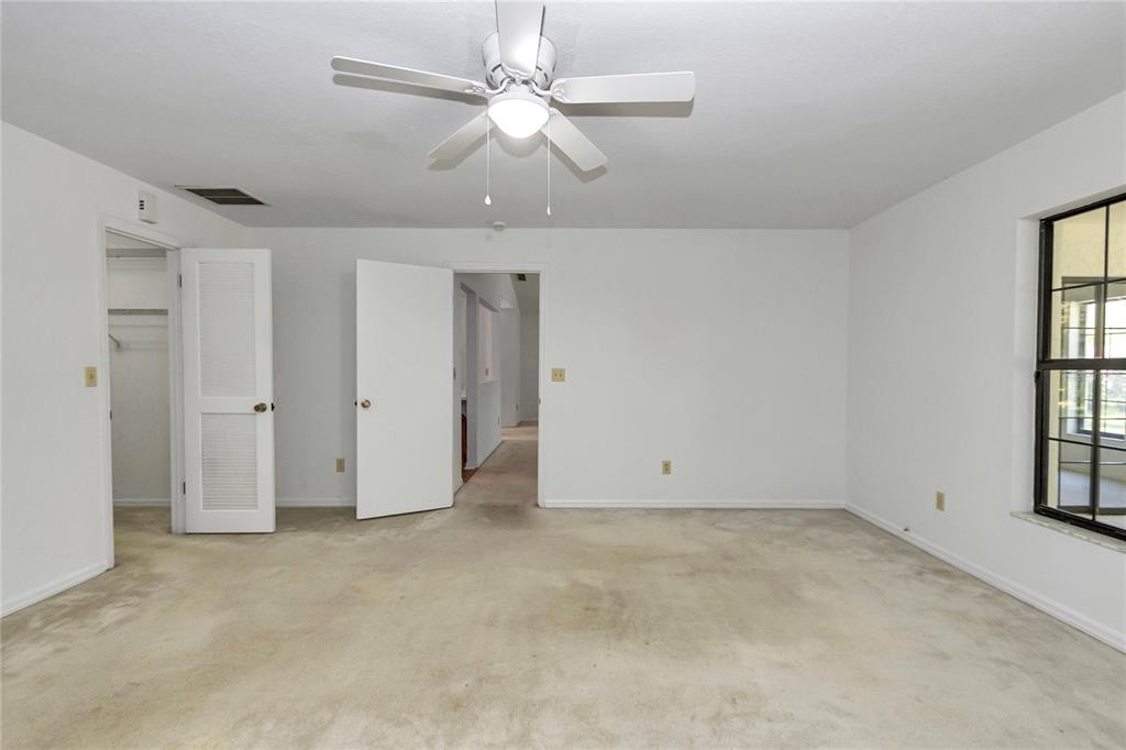 8160 Southwest 53rd Court Ocala, FL 34476 - Photo 39 of 54 an empty room with windows and fan