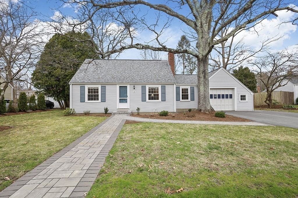 8 Leland Road Natick, MA 01760 - Photo 1 of 21 a view of a white house with a large pool and lawn chairs under an umbrella