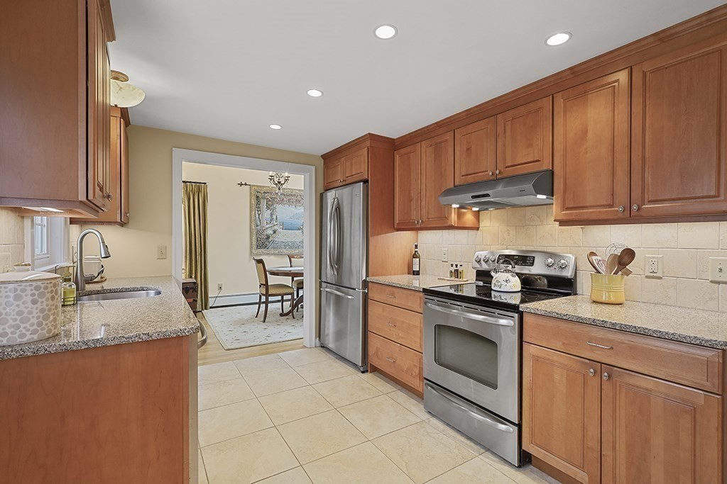 8 Leland Road Natick, MA 01760 - Photo 3 of 21 a kitchen with stainless steel appliances granite countertop a sink stove refrigerator and cabinets