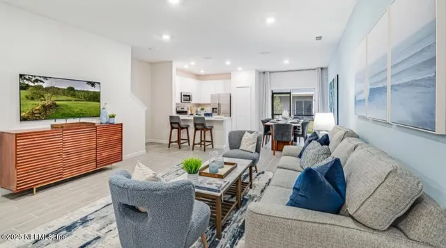 a living room with furniture and a flat screen tv