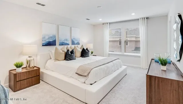 a bedroom with bed and window