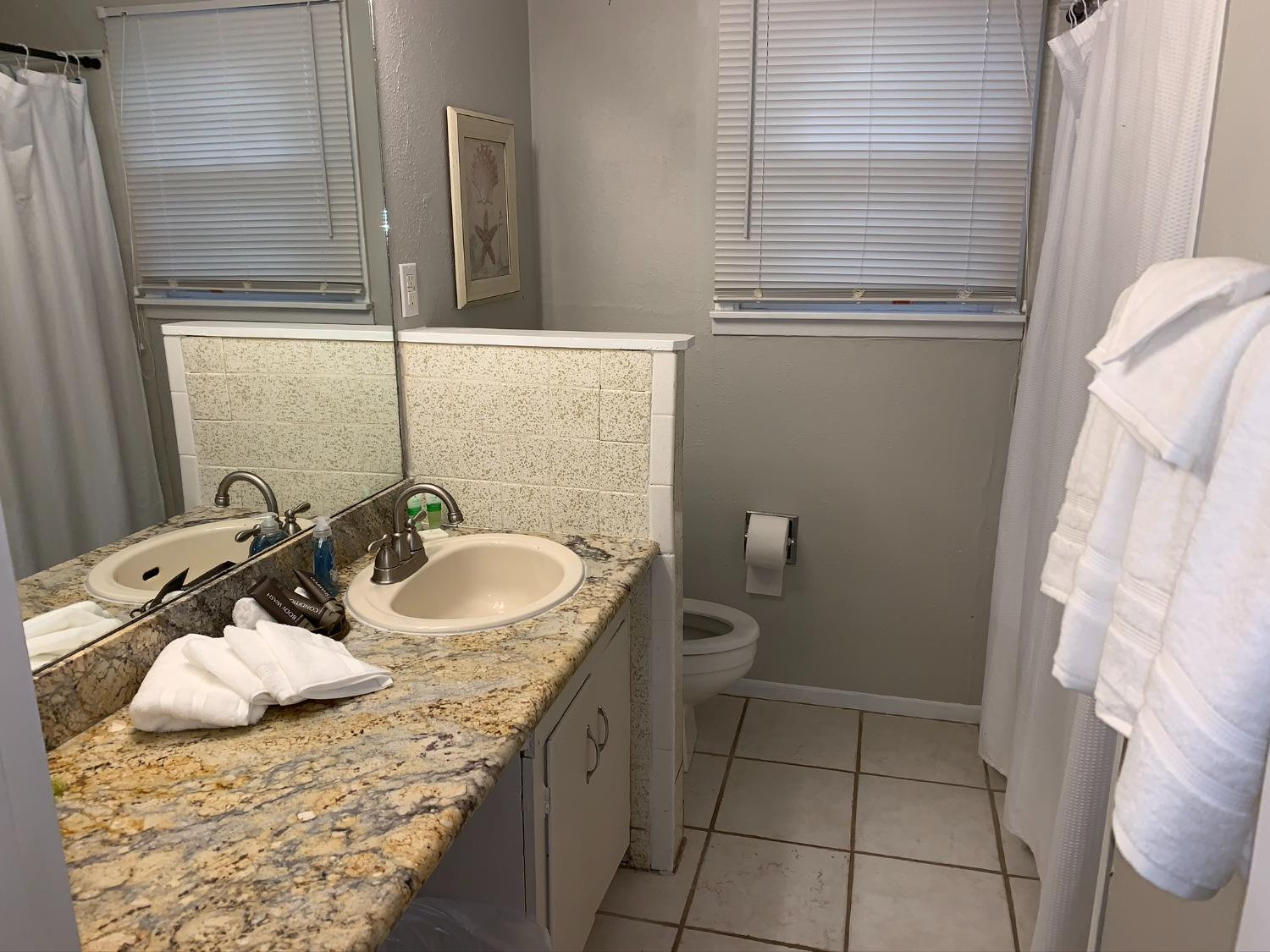 5009 16th Street Lubbock, TX 79416 - Photo 13 of 16 a bathroom with a sink toilet and shower