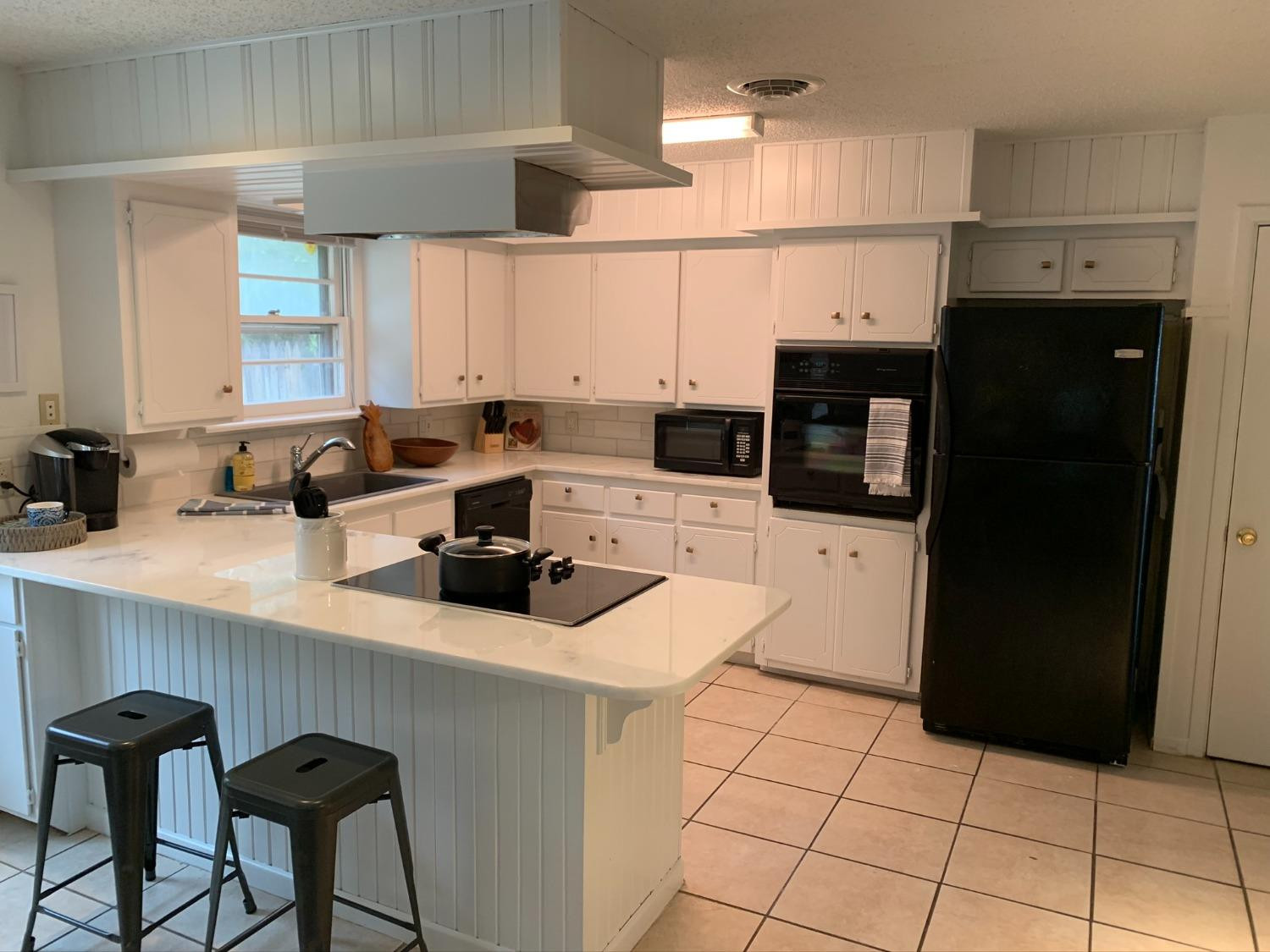 5009 16th Street Lubbock, TX 79416 - Photo 4 of 16 a kitchen with stainless steel appliances a sink a refrigerator a counter top space and cabinets
