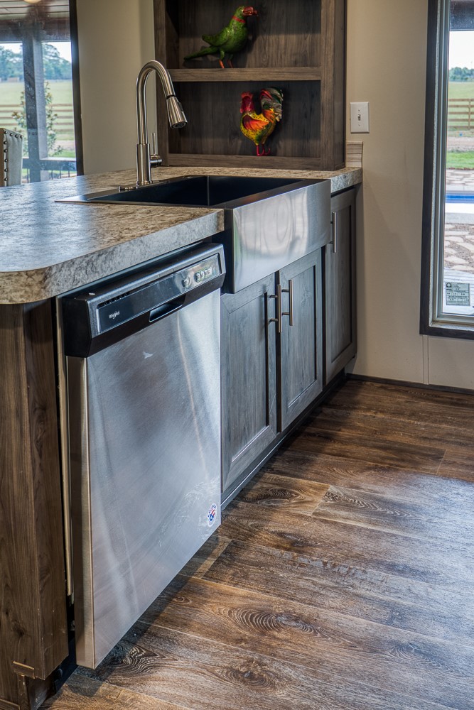 35418 Tompkins Road Hempstead, TX 77445 - Photo 13 of 50 a kitchen with stainless steel appliances granite countertop a sink and a refrigerator