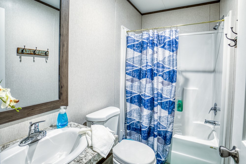 35418 Tompkins Road Hempstead, TX 77445 - Photo 19 of 50 a bathroom with a sink toilet and shower