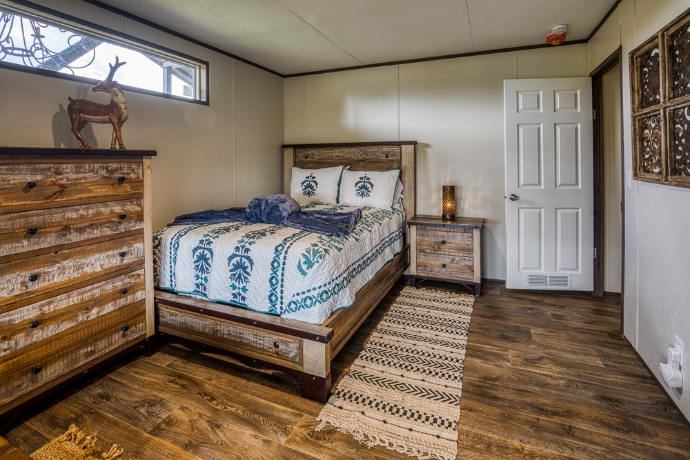 35418 Tompkins Road Hempstead, TX 77445 - Photo 21 of 50 a bedroom with a bed and wooden floor