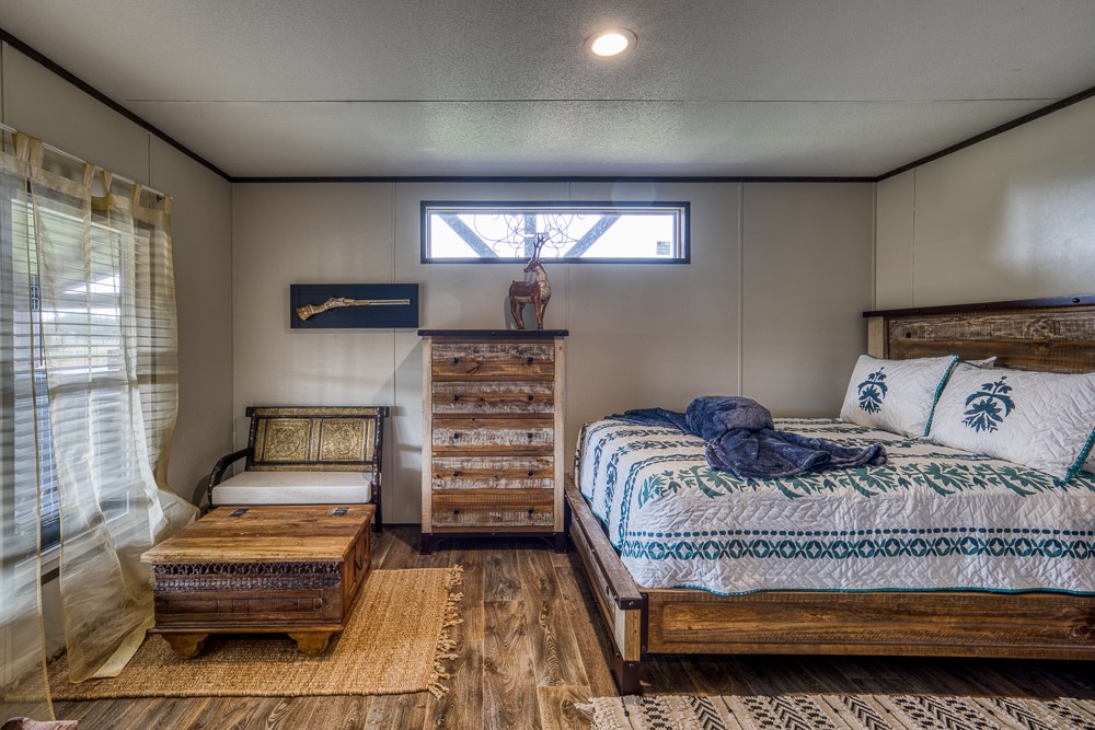 35418 Tompkins Road Hempstead, TX 77445 - Photo 22 of 50 a bedroom with a bed and a couch