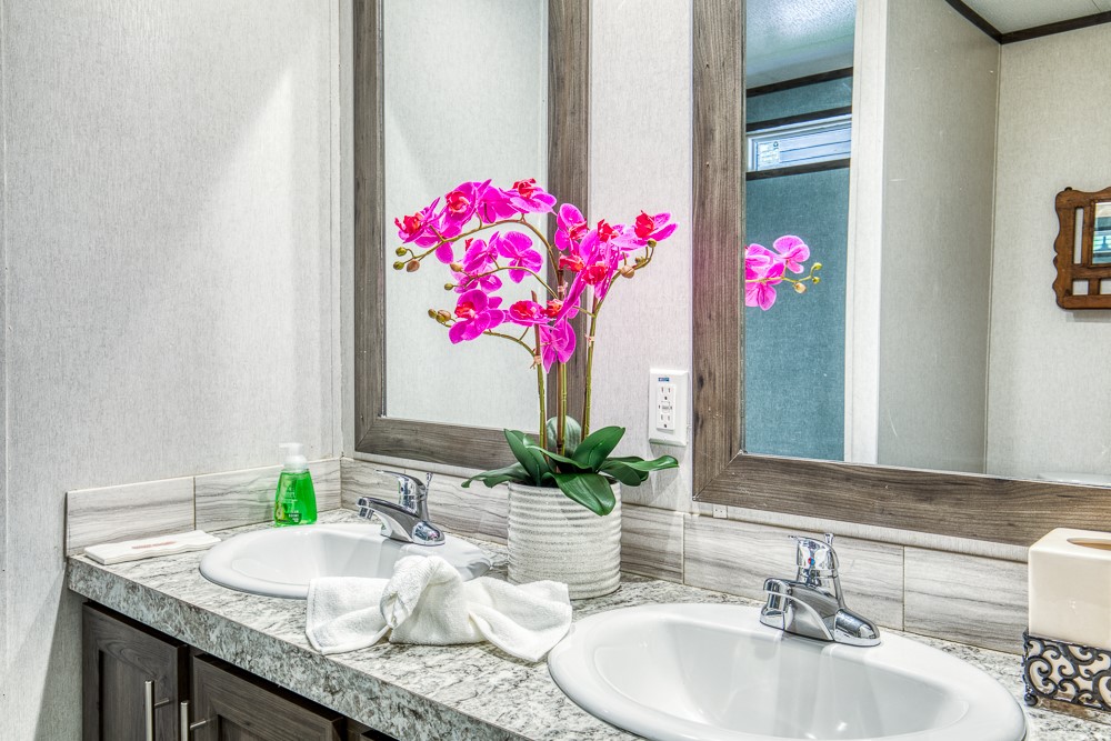 35418 Tompkins Road Hempstead, TX 77445 - Photo 24 of 50 a bathroom with a granite countertop sink and a mirror
