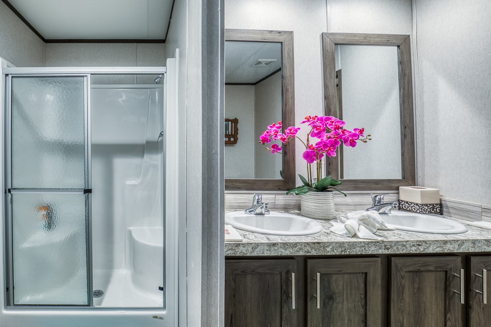 35418 Tompkins Road Hempstead, TX 77445 - Photo 25 of 50 a bathroom with a granite countertop shower a sink and a mirror