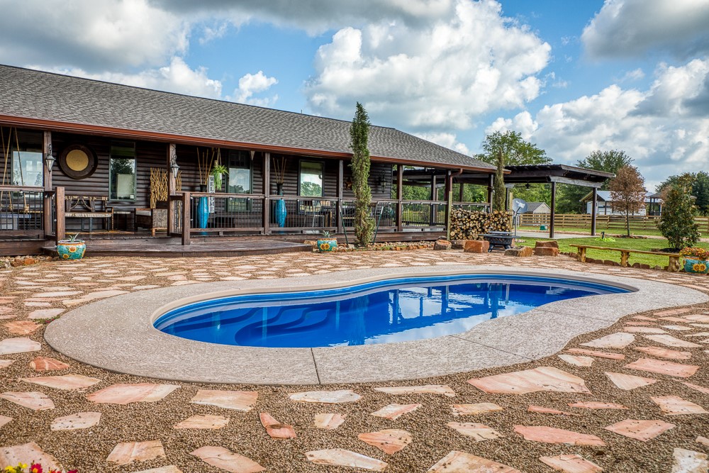 35418 Tompkins Road Hempstead, TX 77445 - Photo 29 of 50 a swimming pool with outdoor seating