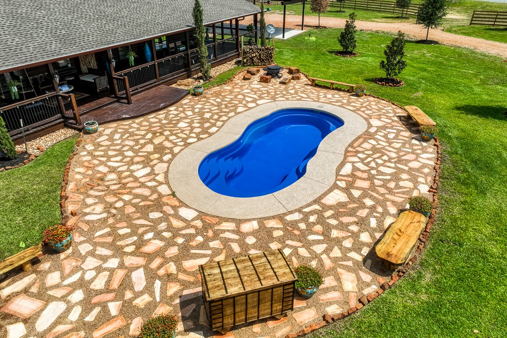 35418 Tompkins Road Hempstead, TX 77445 - Photo 31 of 50 a swimming pool with outdoor seating and yard