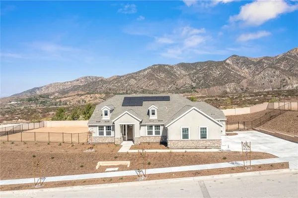 front view of a house with a view of a big yard