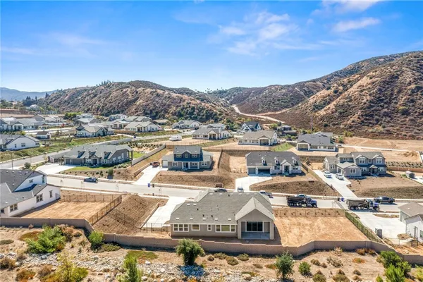 a view of a house with a yard and mountain view