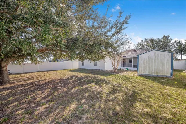 a view of a house with a backyard