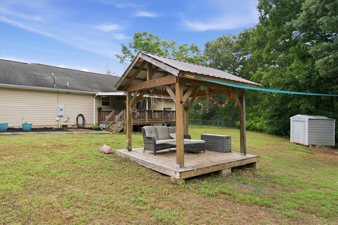 520 Sharon Lane Seneca, SC 29678 - Photo 35 of 48 A spacious backyard with a charming gazebo and practical storage shed.