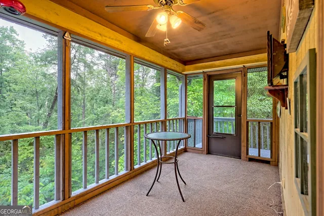 a view of a room with furniture and windows
